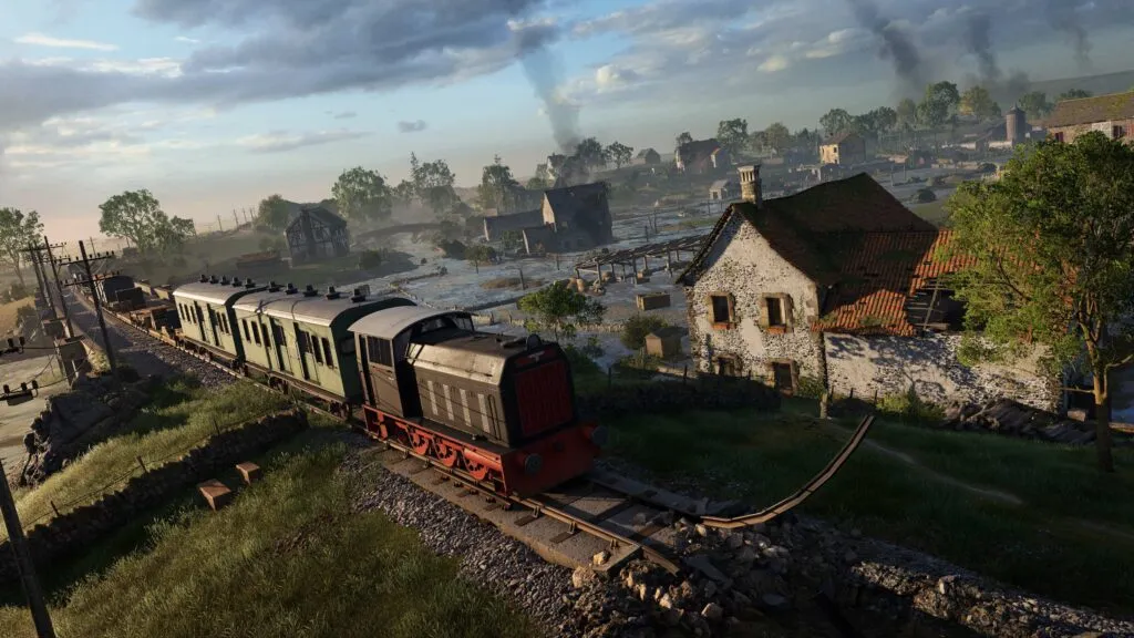 The images shows a train passing through a flooded village.