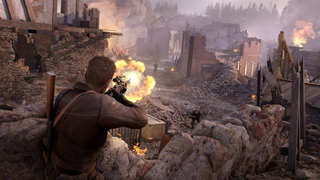 Harry Hawker fires a weapon towards Axis enemies in a war-torn cityscape with damaged buildings and fires in the background.