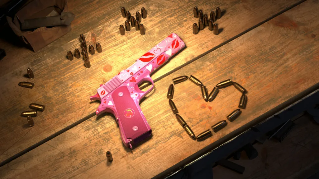 The image shows a workbench with the M1911 Colt pistol laying on top with bullet shells strewn nearby in the shape of a heart and crosses. The weapon is pink with love hearts painted all over.
